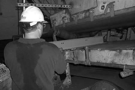 Installation Installing Impact Bars 1. Slide cross-supports under belt in pre-determined location and align with marks. 2.