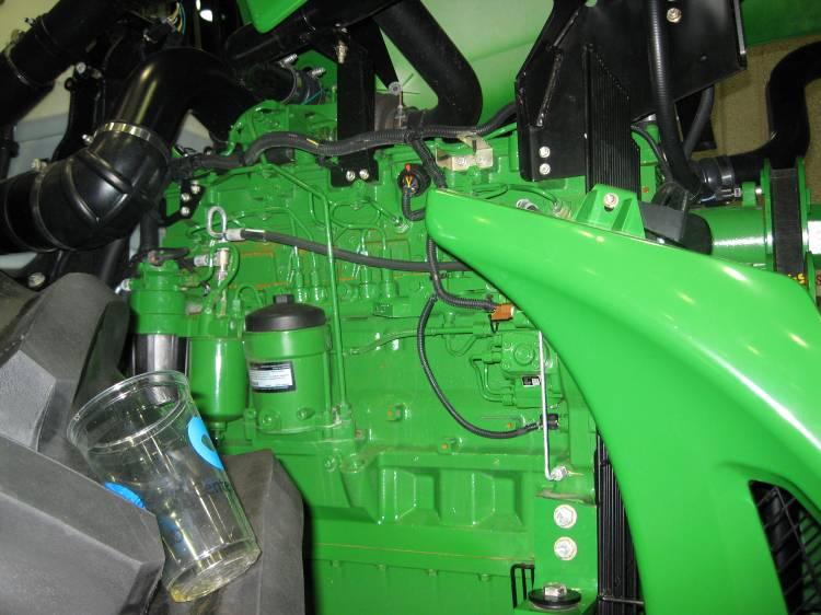 1) From the tractor cab looking forward, locate the fuel system on the right side of the engine.