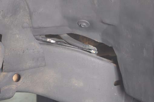 Using pliers, unclip the brake line clips from the body mount, under the driver door.