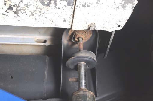 Using a 15mm socket, loosen all the cab mounting bolts. See Photo 27.
