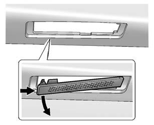Vehicle Care 10-31 Passenger Side Shown, Driver Side Similar 2. Push the left end of the lamp assembly toward the right. 3. Turn the lamp assembly down to remove it from the tailgate. 4.