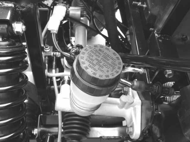 Use shop towels to cover plastic parts and coated surfaces to avoid damage caused by splash of brake fluid.