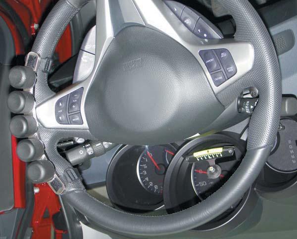 For example, if the vehicle pulls to the right, attach the bracket and weights to the left side of the steering wheel.