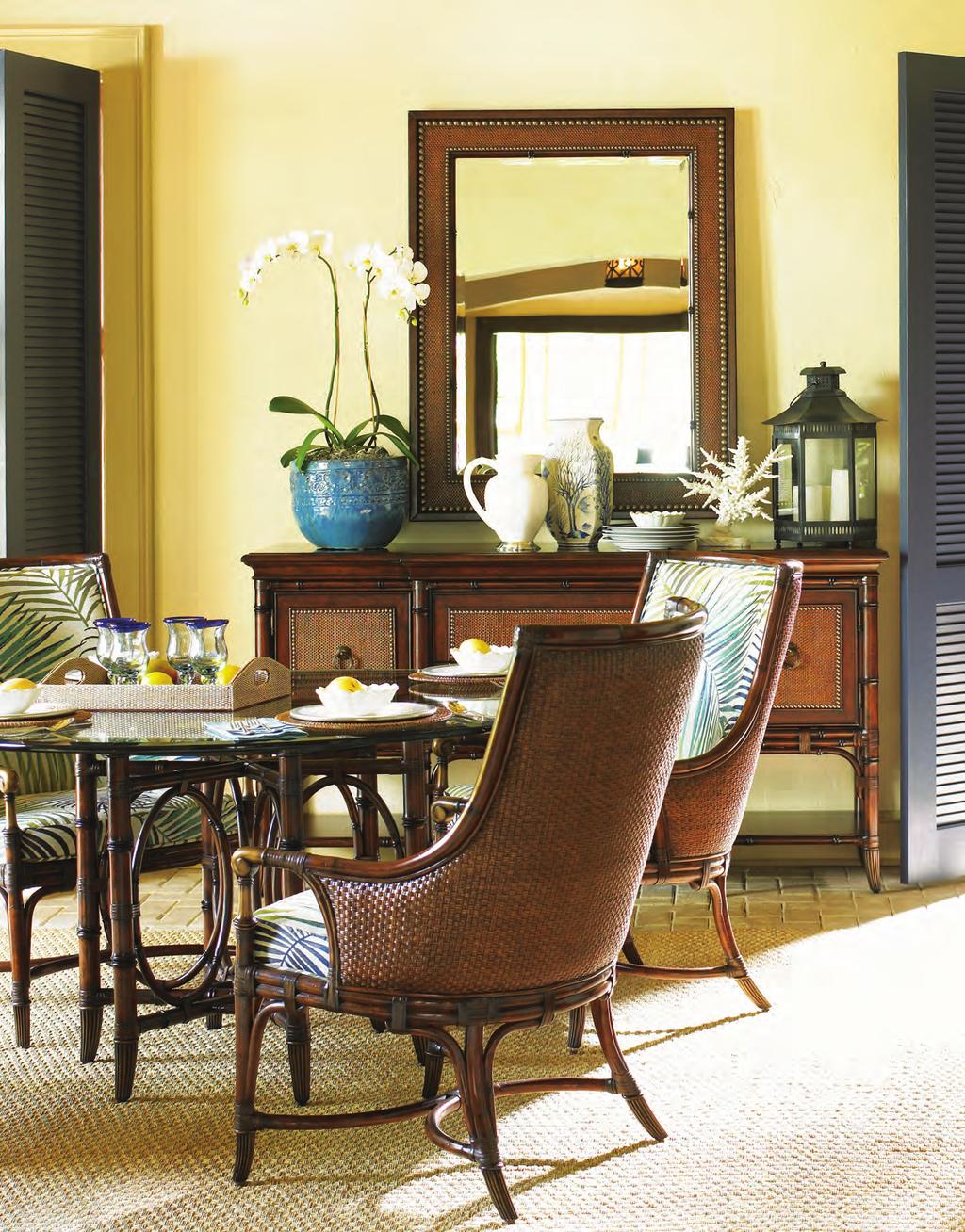 carvings, decorative metal accents and an exquisite stylized palm fabric on the chairs to create an idyllic dining room setting. 545-883 Royal Palm Upholstered Arm Chair 26.