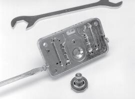7. The power valve can be removed from the metering block with a 1-inch socket, open-end or box wrench (Fig. 6).