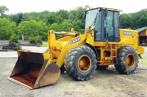 transmission, equipped with general purpose loader bucket with bolt-on cutting edge, hydraulic coupler, auxiliary hydraulics, enclosed ROPS cab, and 17.5R25 tires.