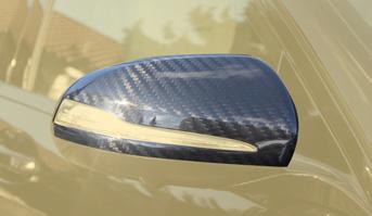Side skirts with visible carbon lips, visible carbon air outtakes Mirror housing LHD Mirror