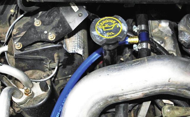 (Image 4) Route hose from top of filter block over aluminum charge pipe and around the engine oil fill tube.