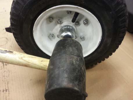 Carefully tap hub cap into place with rubber mallet.