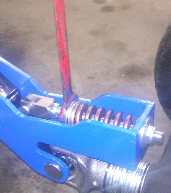 b Adjust spring tension for operator weight by turning the tension nut as shown.