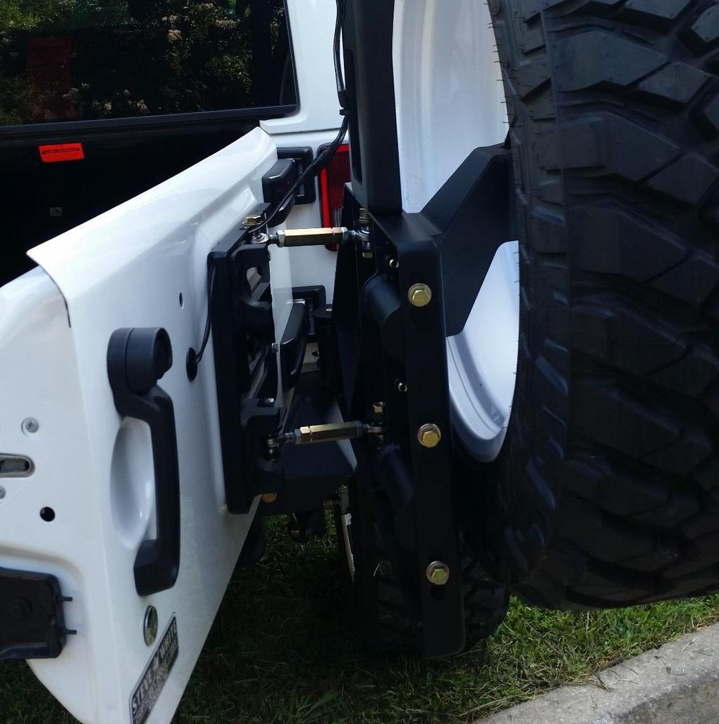 H. Attach the two turnbuckles to both the door plate and the tire carrier using the provided ½ hardware
