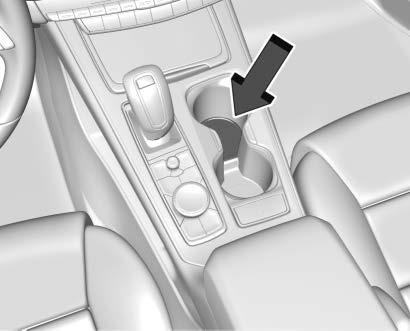 34 KEYS, DOORS, AND WINDOWS Replace the battery if the DIC displays REPLACE BATTERY IN REMOTE KEY. 1. Place the transmitter in the front cupholder. 2.