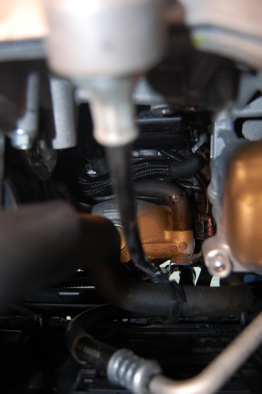 This is the tricky part, with your pliers, move the factory hose clamp off the intake manifold