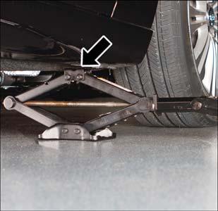 If the vehicle is too low for jack placement, slide the jack on its side and rotate it up into position. 6.