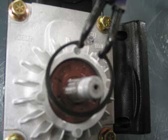 Using a small pry bar or flat head screwdriver, gently pry the fan spacer