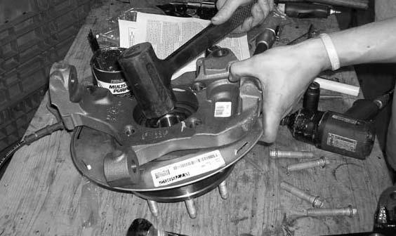 Carefully remove the hub assembly and the steering knuckle from the location and set aside for later re-installation.