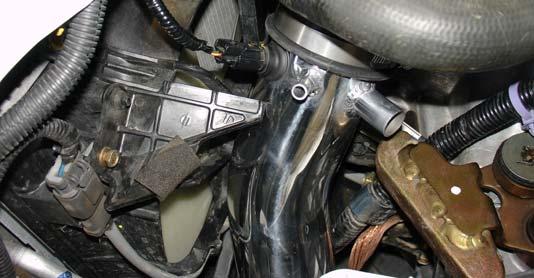 Install the upper portion of the intake through the bumper opening.
