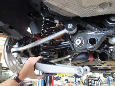 Using a E12 socket, remove the (3) bolts that hold the upper aluminum shock