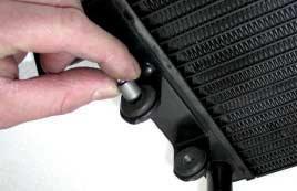 6 INSERT THE RUBBER DAMPENERS INTO THE FIXING HOLES OF THE RADIATOR