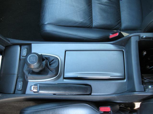 2 1. Remove the center console by tugging gently against the retaining clips on the underside.