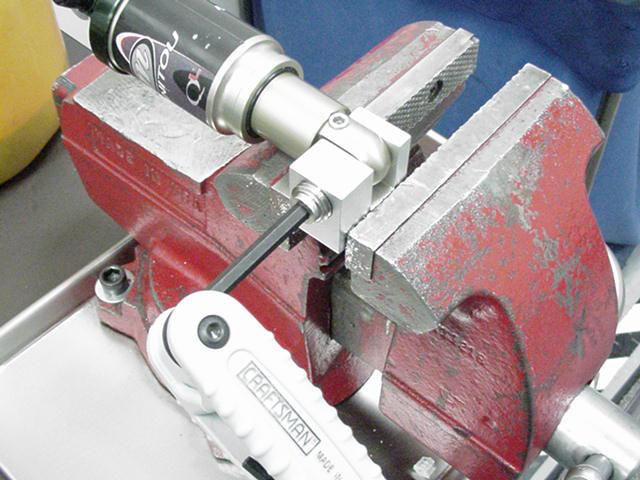 DU USHING REMOVAL AND INSTALLATION (CONT.) 3. Clamp removal tool in vise. 4. Insert eyelet into tool. 5.