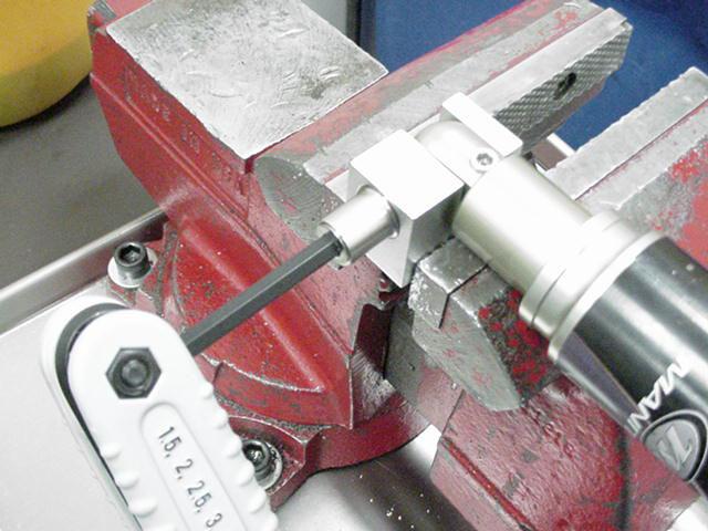 ushing 2. Clamp removal tool in vise. 3. Insert eyelet into tool. 4.