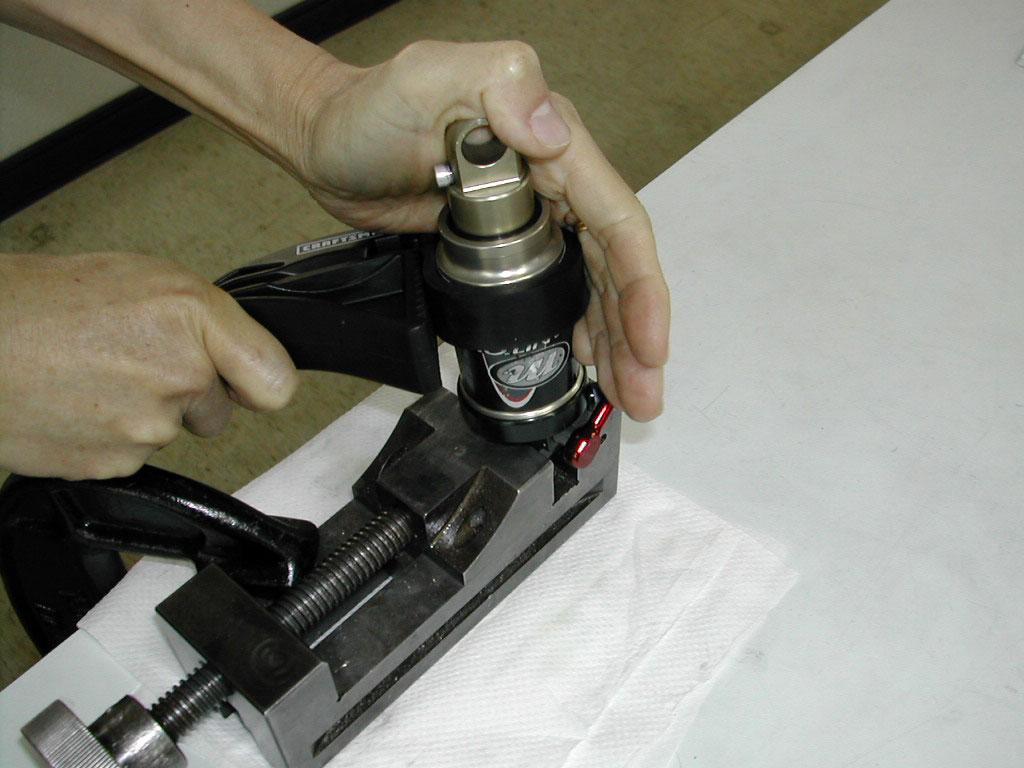 For leaks at the Schrader valves, release all air pressure and replace the Schrader valve core or assembly as needed. The core is removed using a standard core removal tool.