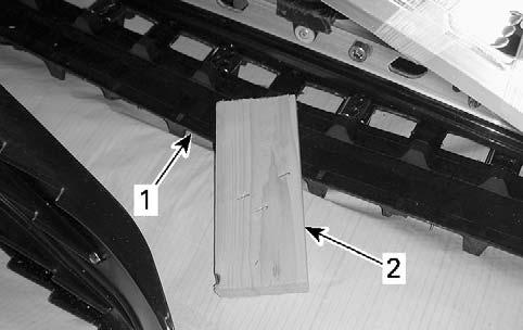 1- UNCRATING mbl2010-003-001_a 1. Track 2. Wood block 5. Remove vehicle from crate base.