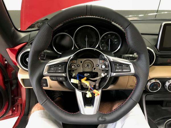 5. CorkSport Wheel Installation a) Install the OE components onto the CorkSport steering wheel in reverse order.