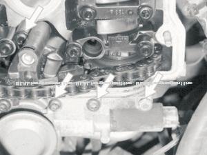 (Image 2) 15) When the valve cover is off, slide in the special tool TR016 (3366) into bottom side of cam chain tensioner and very