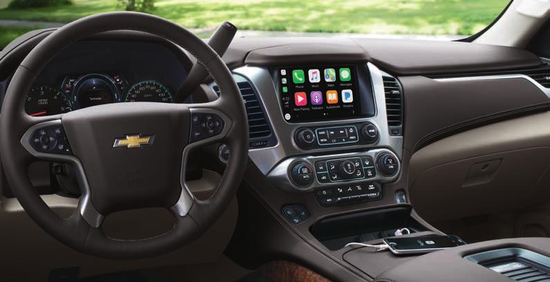 TECHNOLOGY Suburban Premier interior in Dune with Cocoa Accents and available features. Apple CarPlay COMPATIBILITY. 1 MAINTAIN YOUR CONNECTIONS. SIRIUSXM RADIO.