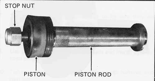 Discard if damaged or worn. Figure 4-13 Removing piston rod clamp 3. Remove suction valve retainer and guide. 4. Completely retract the extension rod and remove the piston rod clamp (Figure 4-13).