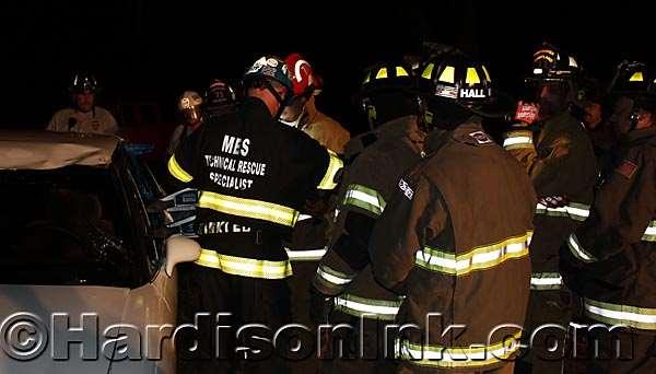 The glowing bars on the firefighters' coats light up because the camera flash is reflected from them. It was dark where the men were training.