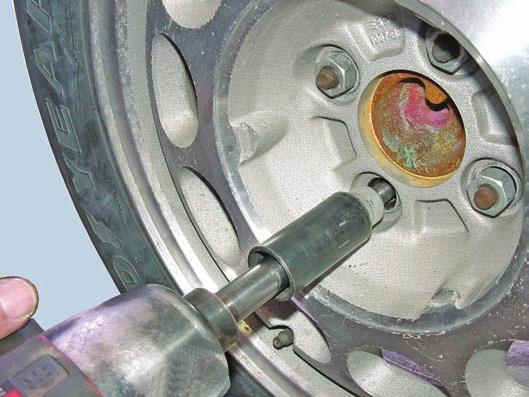 If additional effort is needed, a tie-rod press can be used to force the lug bolt out of its hole. A new lug stud is installed using an inverted lug nut and washers as shown in Figure 62.20.