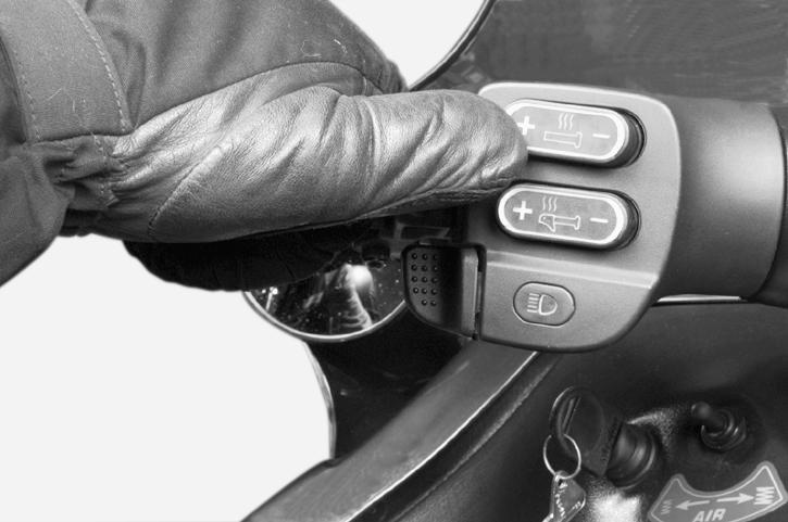 11) Heated Grip Switch This toggle-type switch allows selecting 5 different intensity of handlebar grip heatings. Each time engine is started low heating is selected.
