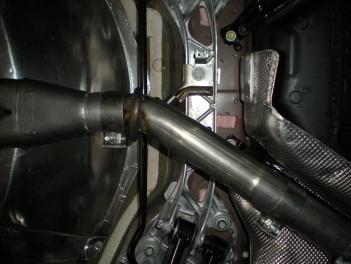 3) Place inlet pipe #570TBS up into position behind the catalytic converter and connect the hangers on the pipe to the rubber mounts on the vehicle.