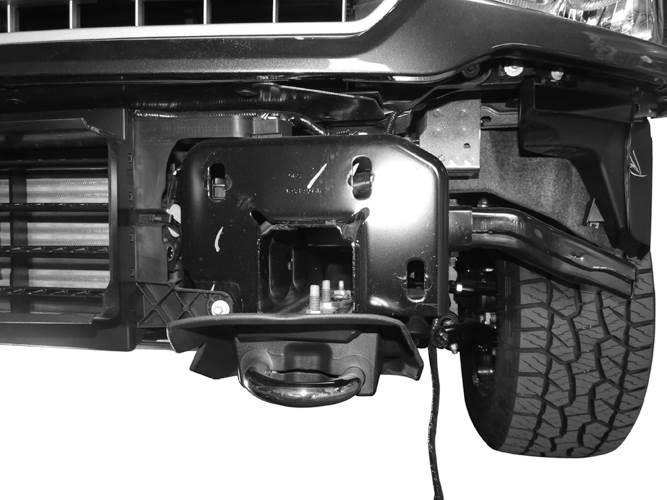 13. On models with grille mounted factory camera, remove the center screen, (Figure 19). 14. With assistance, position the Bumper Assembly onto the outsides of the Frame Brackets.