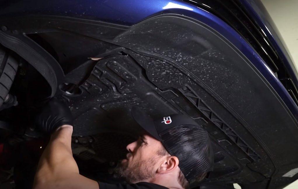 Place a bucket underneath the washer fluid reservoir, to catch excess fluid in