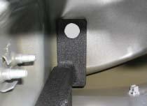 From under-inside of body center punch remaining bracket hole on the