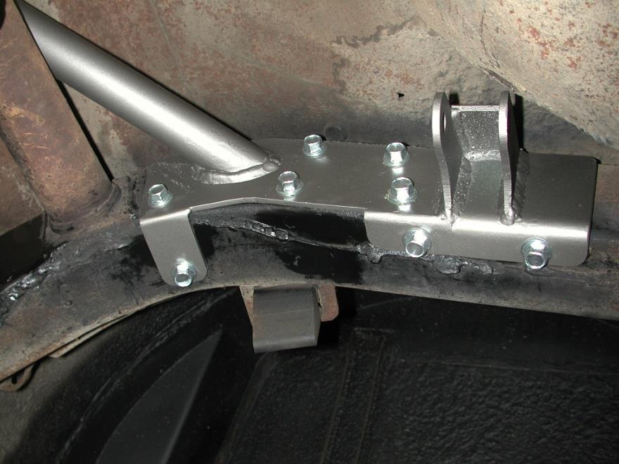5. Slide the cradle into place with the upper Shockwave mount toward the rear of the vehicle. 6. You may need to grind the welds smooth on the bottom of the frame to allow the cradle to sit properly.