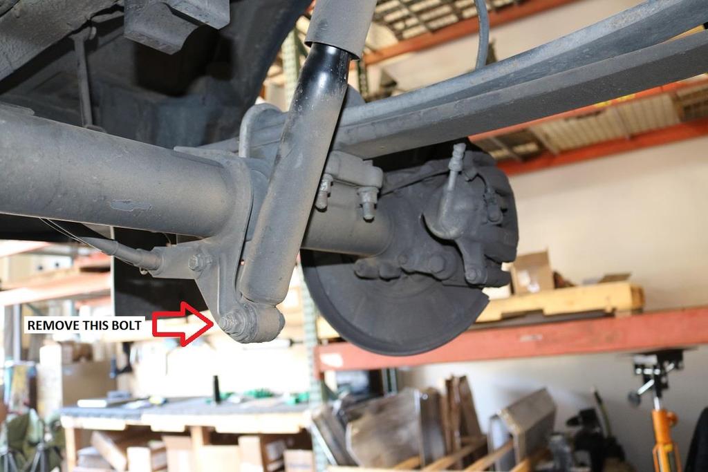 Once the shock is removed, allow the axle to hang freely