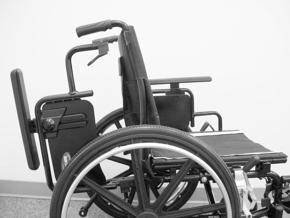 Make sure the flip back armrest is in the locked position before using the wheelchair. 3. Rotate the flip back armrest towards the front of the wheelchair and then downward into the front arm socket.