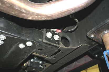 transmission crossmember to frame bolts shown in Figure 18. Only work on one side at a time so the crossmember is never completely loose from the frame.