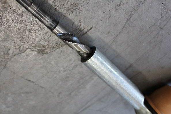 Figure 23 2) Secure the outer tie rod in a vise grip. Using a 9/16 drill bit, drill the hole in the outer tie rod 1 deeper. Then using an M16-1.