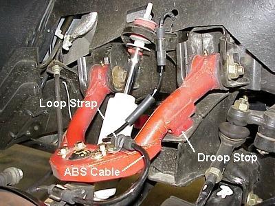 6. Install new Rancho shock absorber. Do not reuse original shock absorber. 7. Align droop stop with control arm pad. Tighten nut securely. See illustration #9. Illustration #10 3.