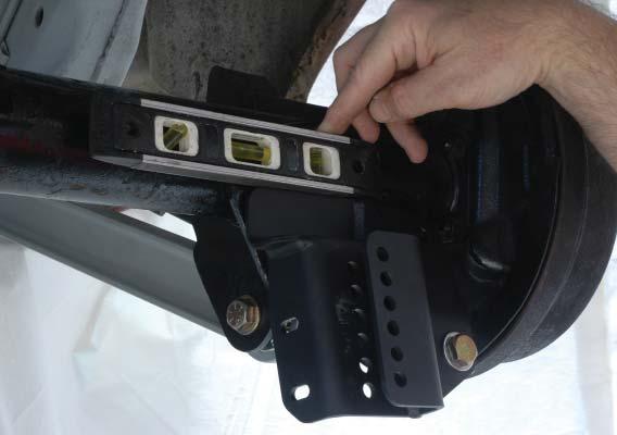 Tighten the 1/2 bolt securing the coil over bracket to the