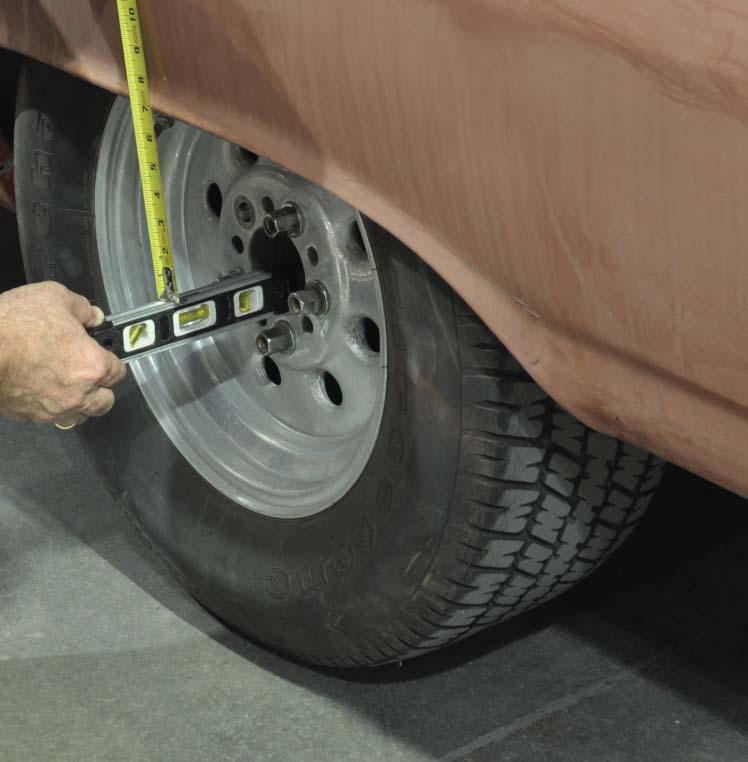 Measure from the center of the axle to the fender lip. Record these measurements. It may be easier to accurately measure from the center of the axle to the ground.