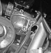 Drain fuel from carburetor into an empty container by loosening the carburetor drain screw. 2. When the fuel has been drained, retighten the drain screw.
