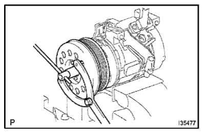 a. Place the compressor and magnetic clutch in a vise. b.