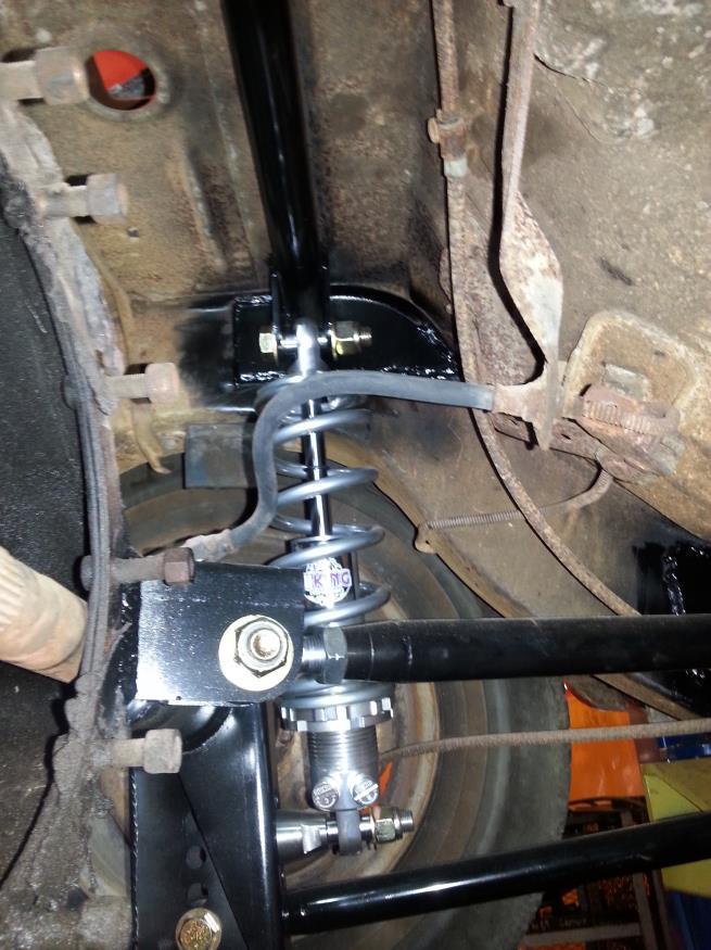 Place the upper coil over mount bar in position and rotate it until it until the curve of the end plate matches the curve on your floor pan, as shown in the picture below (1966-1970 bar shown 71-72